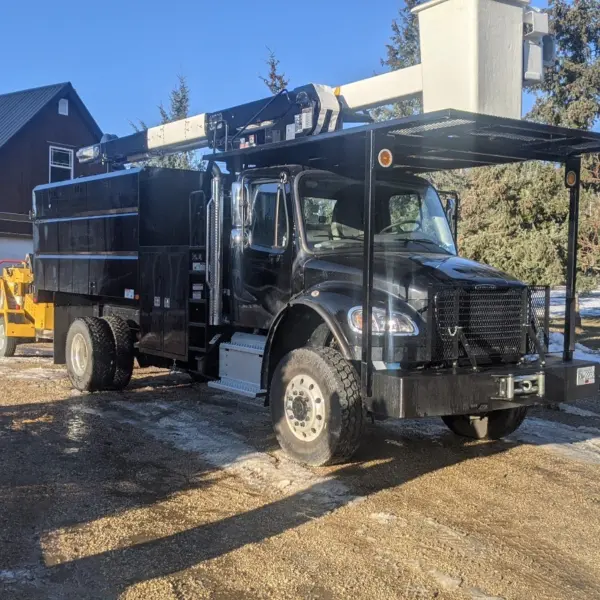 Green Giant Tree Removal truck parked by garage